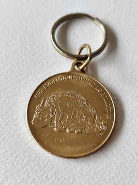 3/$30💜GE's Evolution Hybrid Locomotive" brass medallion keychain